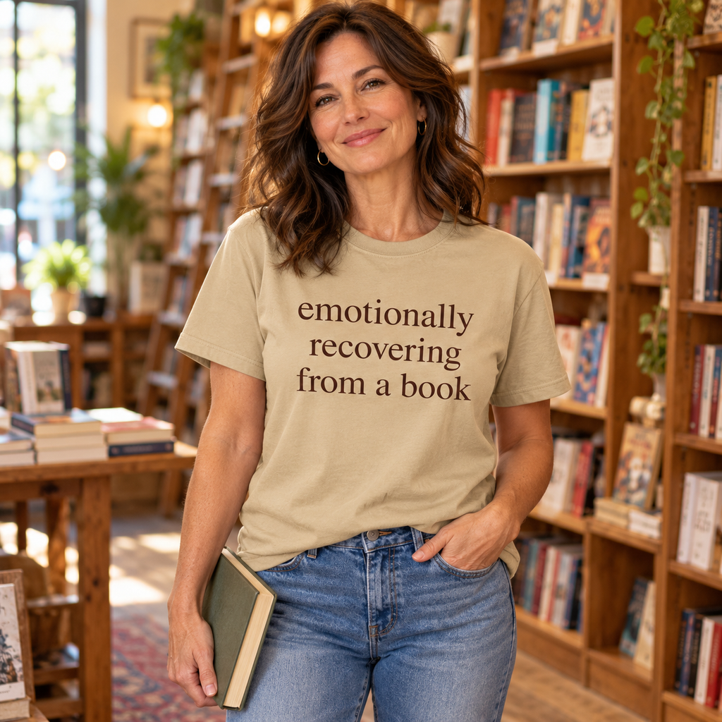 Sand Tshirt. Size S-3XL, Woman wearing an Emotionally recovering from a Book Tshirt in a book store