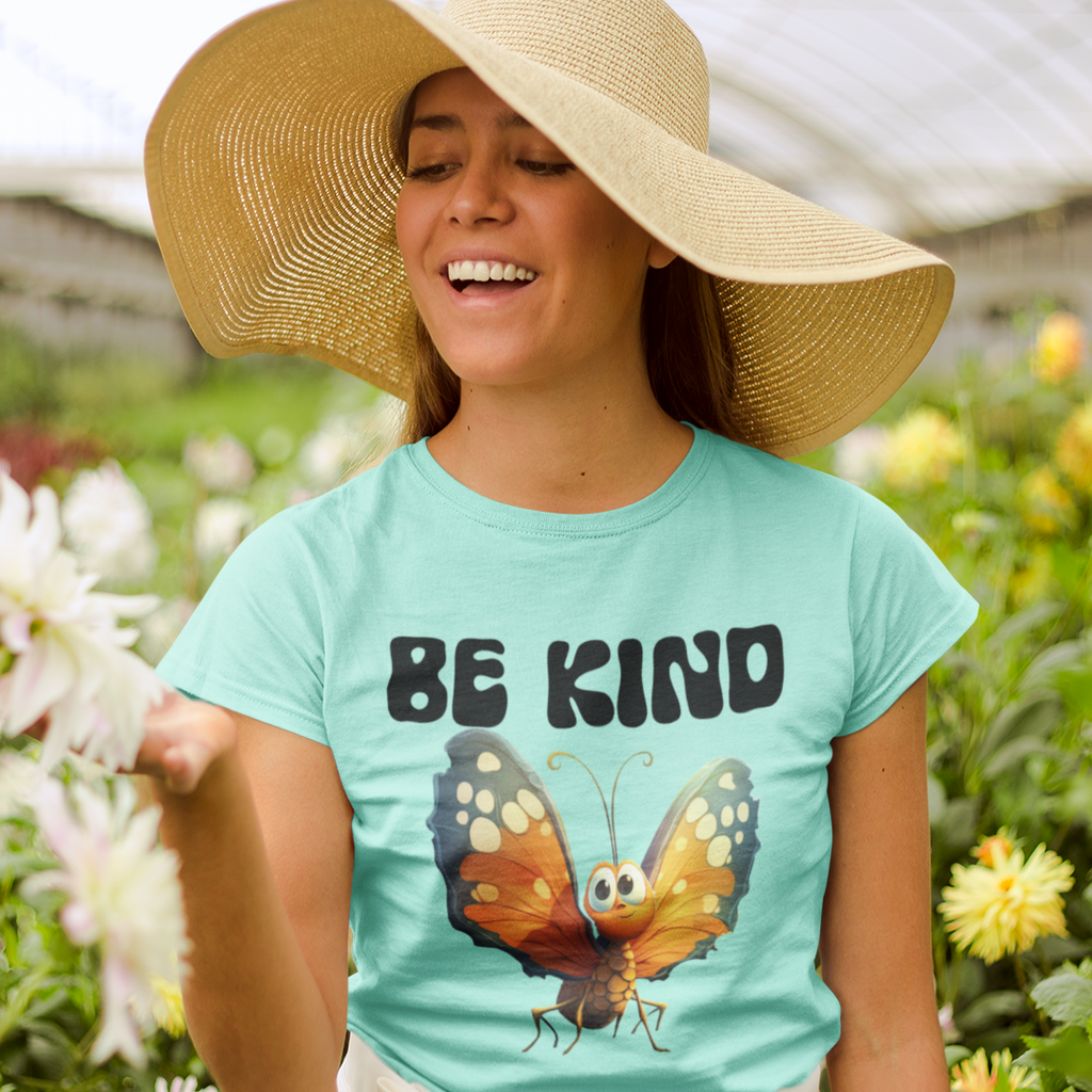 woman wearing the Be Kind Butterfly Iced teal tee at a  garden center