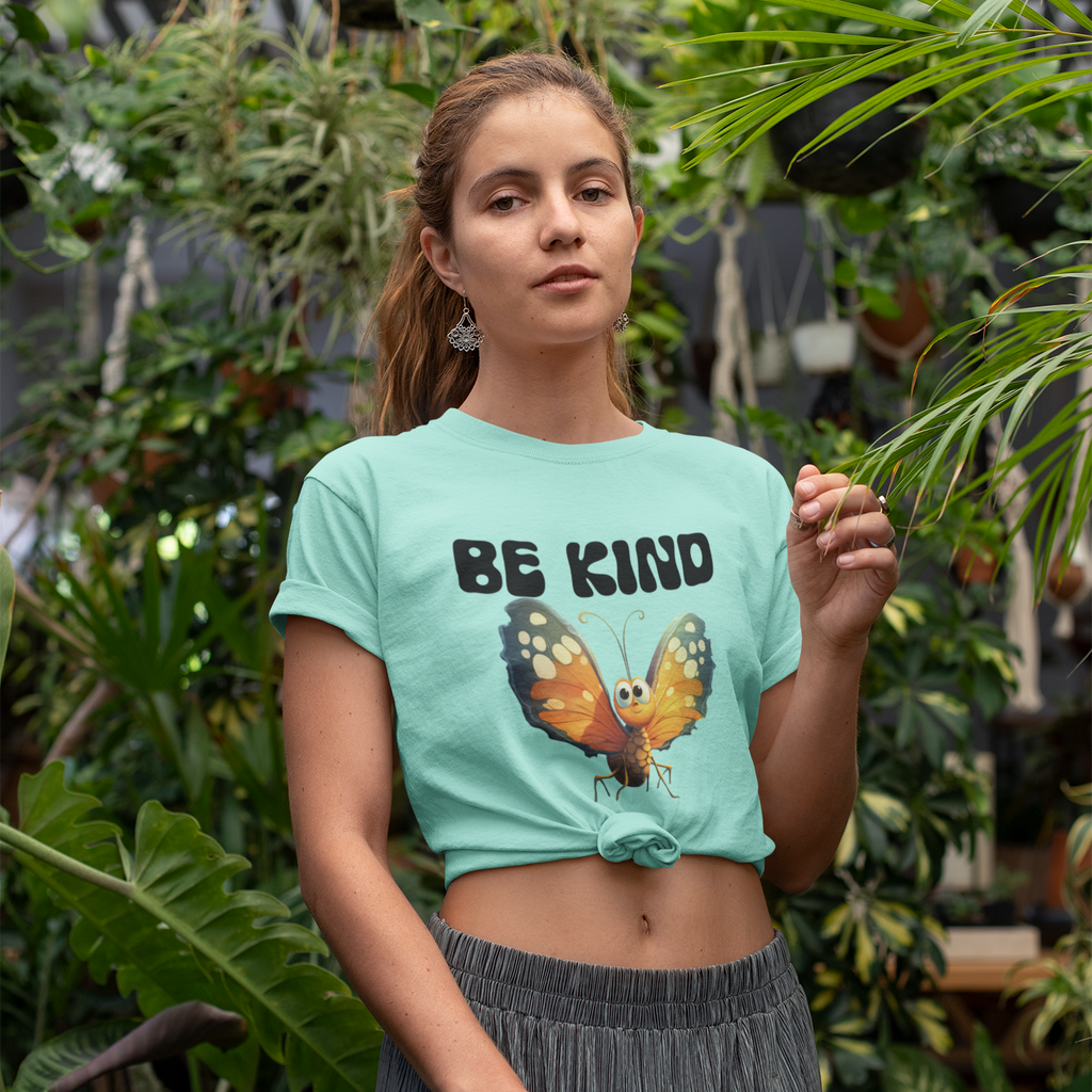 woman wearing BeKind butterfly tee in at a local garden. She has the tee tied above her belly button and is wearing a skirt.