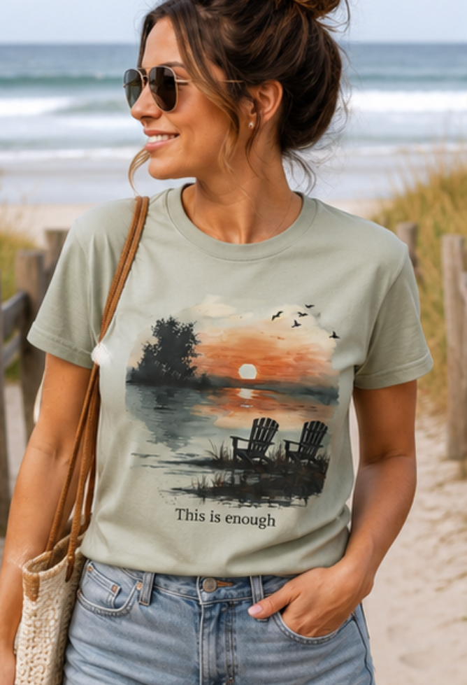 Woman wearing a t-shirt with a beach graphic and text on a beach setting
