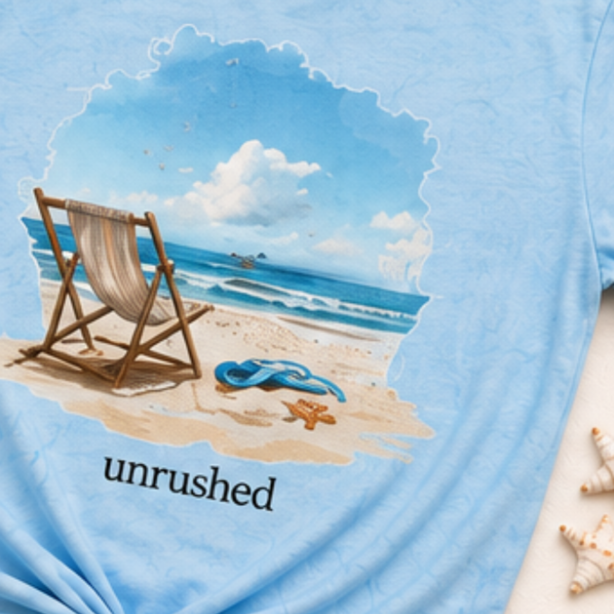 Blue t-shirt with a beach scene and 'unrushed' text on a white background